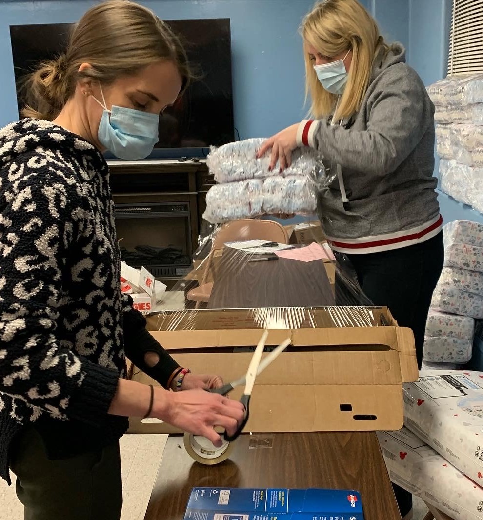 Laura Grajczyk and Collen Lavoy box up diapers.