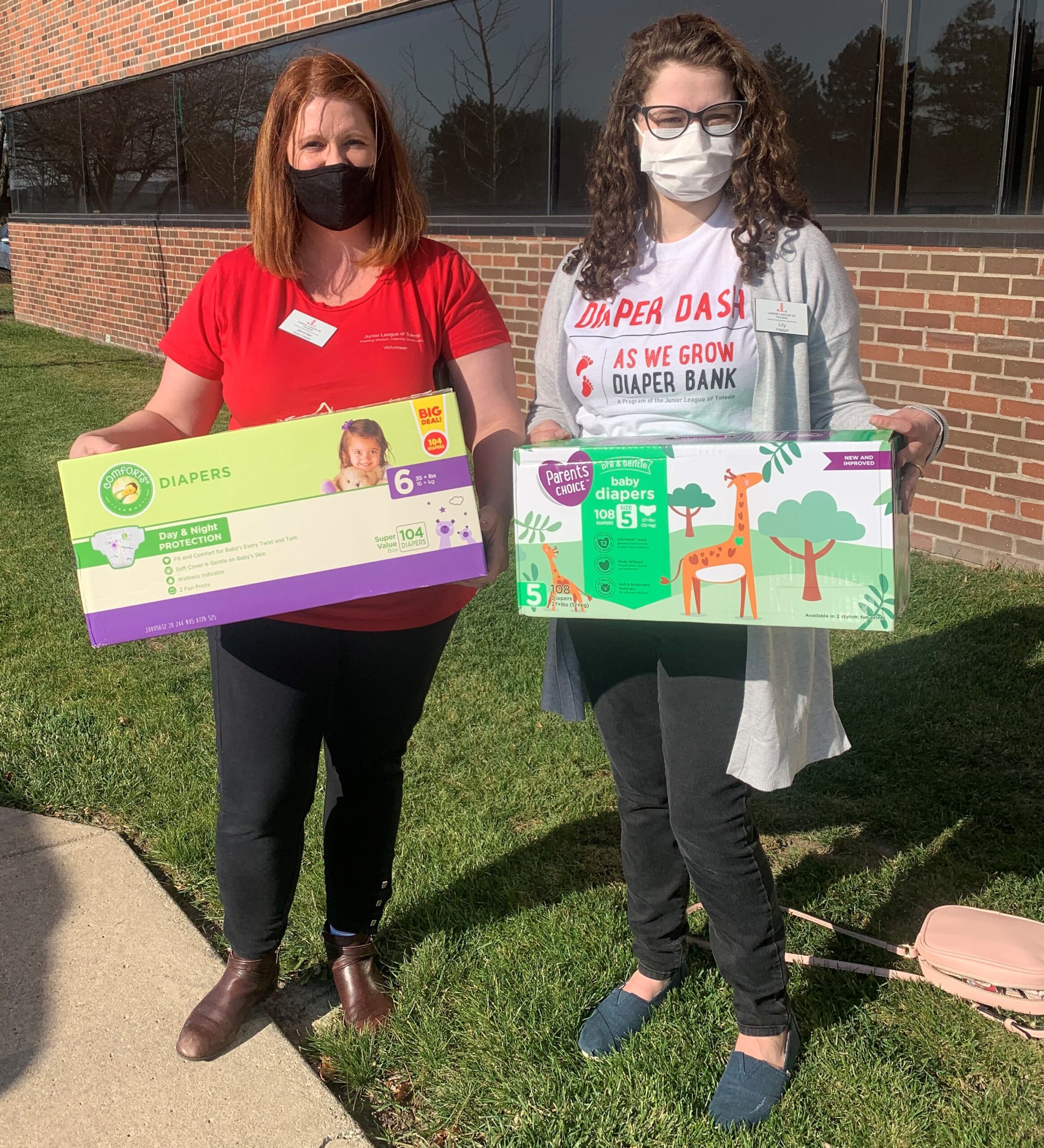 Jennifer Gray Catera and Lilly Hagigat Vrzal holding diaper boxes